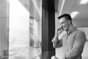 young business man using smart phone at office photo