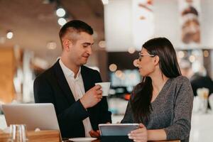 Modern man and woman use modern devices, laptop, tablet and smartphone and arrange new projects for the job. Business concept . photo