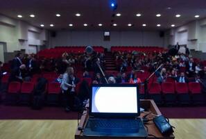 laptop computer and microphone at podium photo