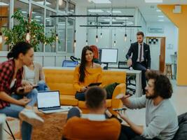 Multiethnic group of employees working in a marketing company. A group of colleagues is working on a project in modern offices photo