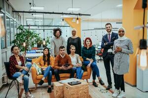 Group of multi-ethnic colleagues working on desktop computers, laptop and sharing their ideas in a modern office space.Young influencers work on online marketing projects. photo