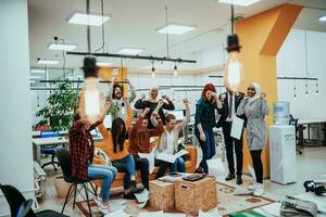 Group of business people throwing paper in air at modern startup office, team success and job done concept photo