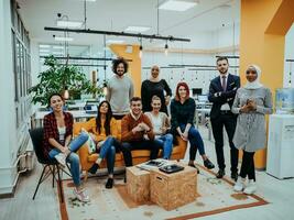 Group of multi-ethnic colleagues working on desktop computers, laptop and sharing their ideas in a modern office space.Young influencers work on online marketing projects. photo