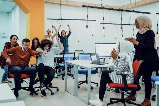 Team building and office fun. Young cheerful businesspeople in smart casual wear having fun while racing on office chairs and smiling. photo