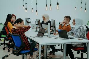 Multiethnic group of employees working in a marketing company. A group of colleagues is working on a project in modern offices photo
