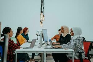 Multiethnic group of employees working in a marketing company. A group of colleagues is working on a project in modern offices photo