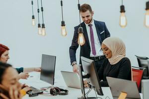 Multiethnic group of employees working in a marketing company. A group of colleagues is working on a project in modern offices photo