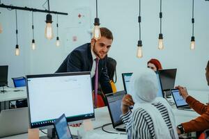 Multiethnic group of employees working in a marketing company. A group of colleagues is working on a project in modern offices photo