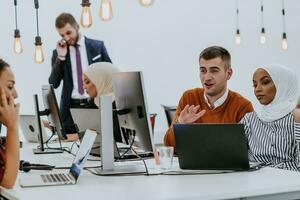 Multiethnic group of employees working in a marketing company. A group of colleagues is working on a project in modern offices photo