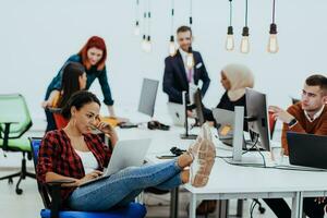 Multiethnic group of employees working in a marketing company. A group of colleagues is working on a project in modern offices photo