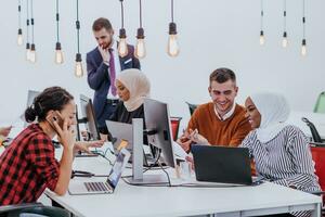 Multiethnic group of employees working in a marketing company. A group of colleagues is working on a project in modern offices photo