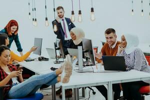 Multiethnic group of employees working in a marketing company. A group of colleagues is working on a project in modern offices photo