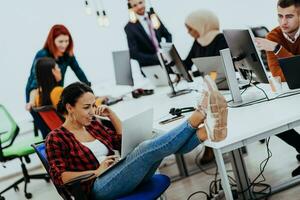 Multiethnic group of employees working in a marketing company. A group of colleagues is working on a project in modern offices photo