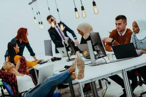 Multiethnic group of employees working in a marketing company. A group of colleagues is working on a project in modern offices photo