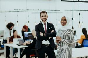 Portrait of a formal businessman and young African American businesswoman posing with their team in a modern startup office. Marketing concept. Multi-ethnic society. photo