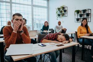 Tired woman napping on the table during a lecture in the classroom photo