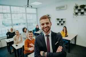 A group of diverse young men and women sit in a modern classroom and listen to a lecture on business training photo