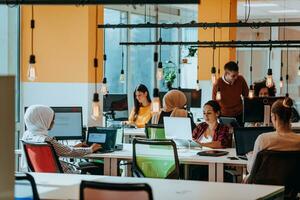Multiethnic group of employees working in a marketing company. A group of colleagues is working on a project in modern offices photo
