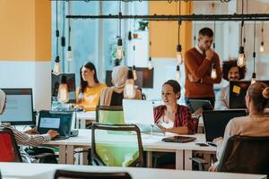 Multiethnic group of employees working in a marketing company. A group of colleagues is working on a project in modern offices photo