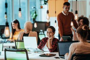 Multiethnic group of employees working in a marketing company. A group of colleagues is working on a project in modern offices photo