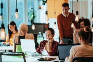 Multiethnic group of employees working in a marketing company. A group of colleagues is working on a project in modern offices photo