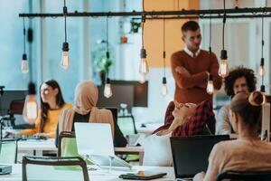 Multiethnic group of employees working in a marketing company. A group of colleagues is working on a project in modern offices photo