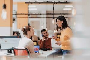 Multiethnic group of employees working in a marketing company. A group of colleagues is working on a project in modern offices photo
