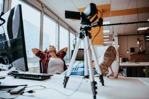 A young woman using a camera to present her business with online clients photo