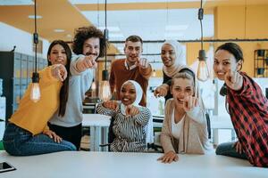 Multiethnic group of employees working in a marketing company. A group of colleagues is working on a project in modern offices photo