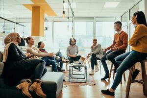 Young designer giving some new ideas about project to his partners in conference room. Business people discussing over new business project in office. photo