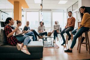 Young designer giving some new ideas about project to his partners in conference room. Business people discussing over new business project in office. photo