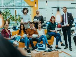 Multiethnic group of employees working in a marketing company. A group of colleagues is working on a project in modern offices photo