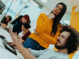 Group of multi-ethnic colleagues working on desktop computers, laptop and sharing their ideas in a modern office space.Young influencers work on online marketing projects. photo