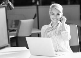 Businesswoman using headset at work photo