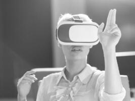 Young woman using vr glasses photo