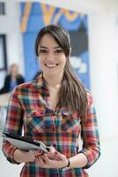 portrait of young business woman at office with team in background photo