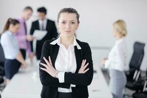 business woman standing with her staff in background photo