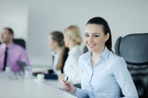 business woman standing with her staff in background photo