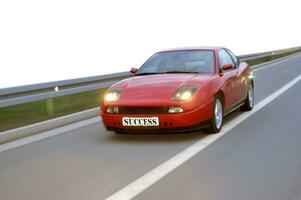 Isolated tuning cars racing on highway photo