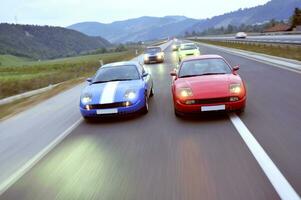 Tuning cars sacing down the highway photo