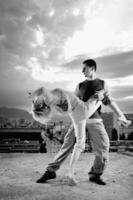 romantic urban couple dancing on top of  bulding photo