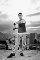 young man jumping in air outdoor at night ready to party photo