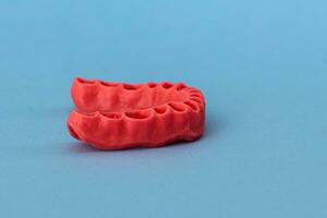 human gums without teeth model medical implant isolated on blue background. Healthy teeth, dental care and orthodontic concept. photo