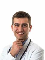 Portrait of hero in white coat. Cheerful smiling young doctor with stethoscope in medical hospital standing against white background. Coronavirus covid-19 danger alert photo