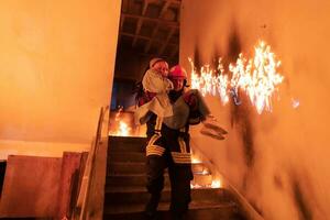 valiente bombero desciende escalera de un ardiente edificio y sostiene salvado niña en su brazos. abierto fuego y uno bombero en el antecedentes. foto