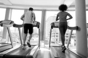 people exercisinng a cardio on treadmill in gym photo