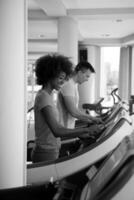 people exercisinng a cardio on treadmill in gym photo