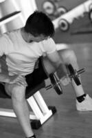 handsome man working out with dumbbells photo