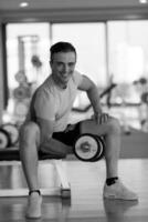 handsome man working out with dumbbells photo