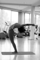 african american woman exercise yoga in gym photo